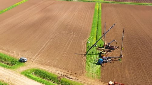 Aerial View of Utility Pole Installation in Rural Field