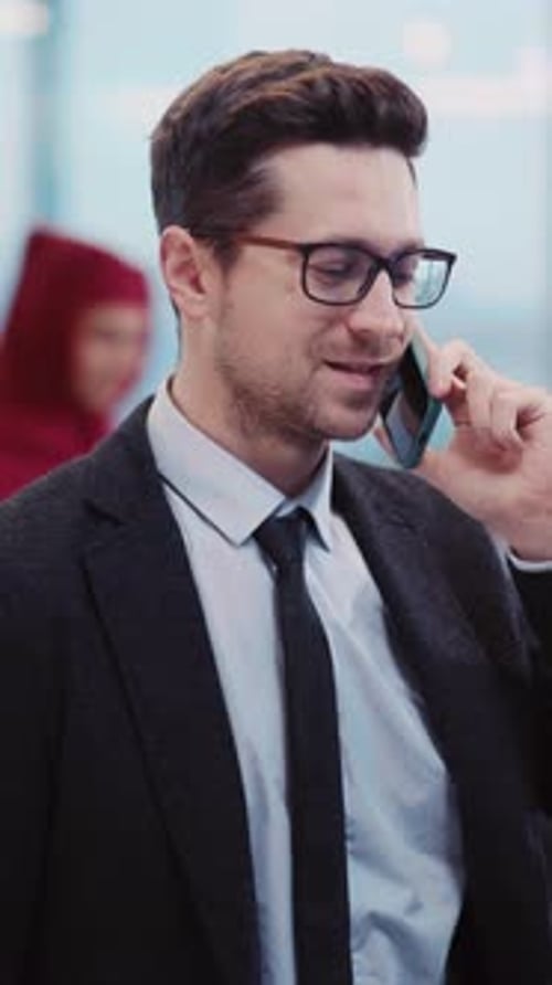 Man Talking on Phone in Modern Office