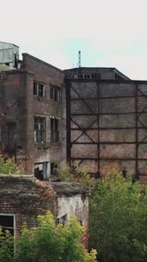 Aerial view from the air to an abandoned factory. Old industrial building for demolition.