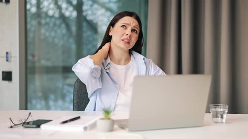 Woman Massaging Neck, Feeling Pain While Using Laptop