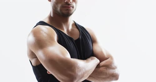 Young biracial athlete man poses confidently in a gym setting, with copy space on white background