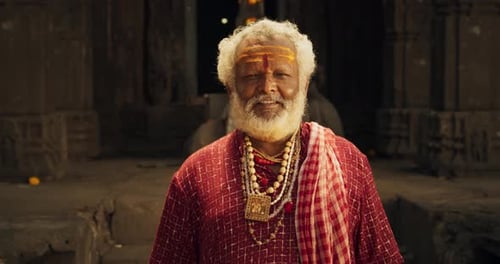 Senior Man Standing in Ancient Temple