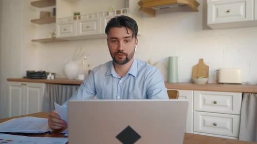 Man Talking During Virtual Meeting in Kitchen