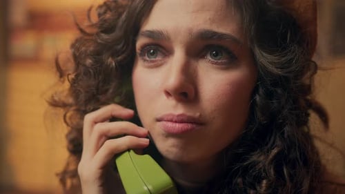 Woman Talking on Phone, Displaying Sad Emotions