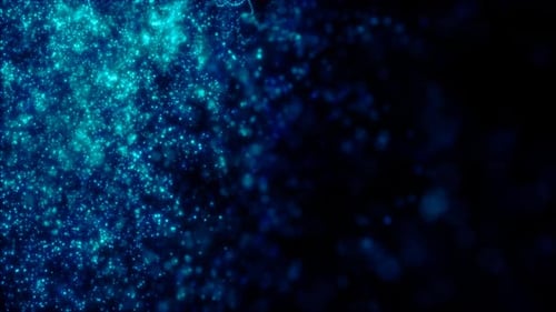 Blurred blue abstract background of bokeh and small round particles of energy magical holiday flying