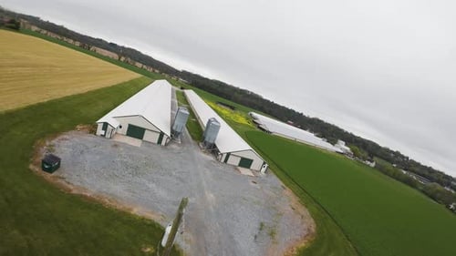 Large Barn for animals and fodder silo on agricultural fields in USA. Organic farming in rural area