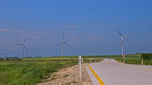Wind Turbines Spinning in a Rural Landscape on Sunny Day