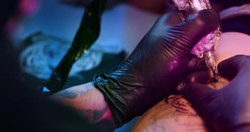 Milan/Italy-01.02.2019:Slow motion of professional master of the art of tattooing doing a tattoo t