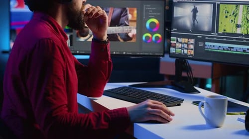 Videographer Operating Computer Editing Systems and Equipment