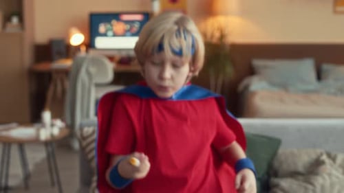Boy in Superhero Costume Playing at Home