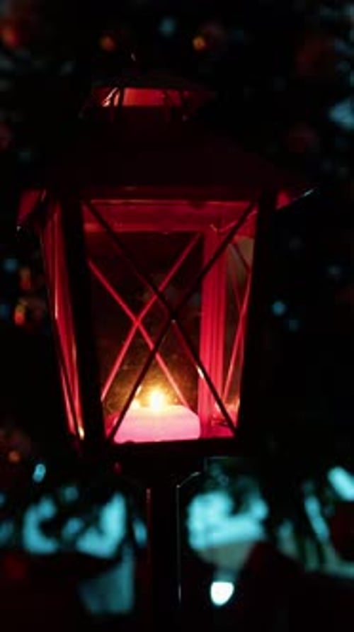 Red Christmas Lantern Rotating In Front Of Silhouette Of The Tree At Night