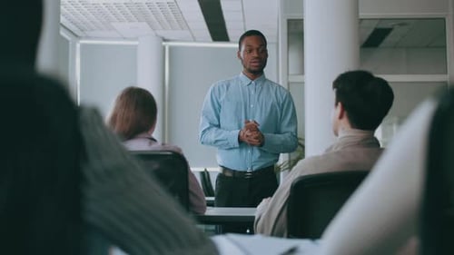 Presenter Speaks to Audience in Bright Office Classroom
