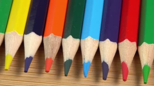 Colorful pencils rotate as a background. Rainbow pencils for drawing. Assortment of colored pencil