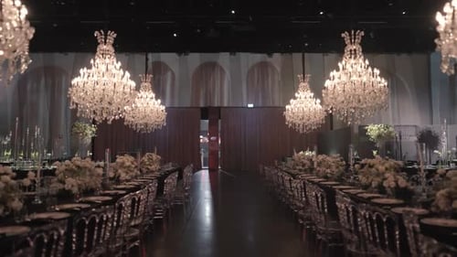 A gimbal movement wide shot of a wedding hall, luxury decoration, flower design, fancy interior, cha