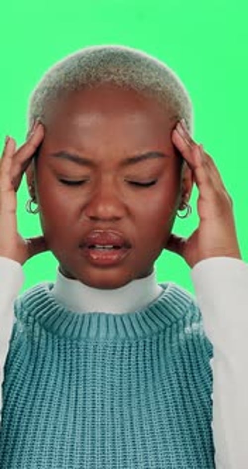 Frustrated, black woman and headache with green screen for stress, anxiety