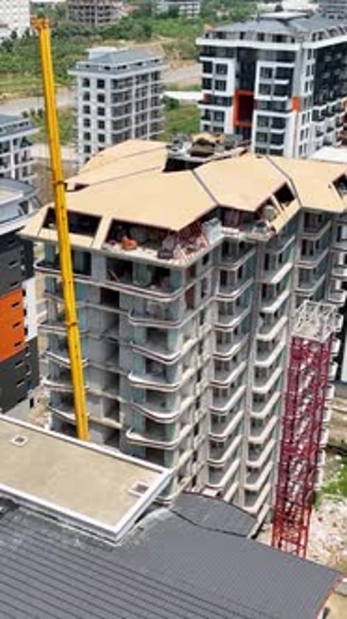 Vídeo vertical desde arriba del progreso de la construcción de un edificio en movimiento