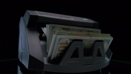 Money Counting Machine Processing US Dollar Bills
