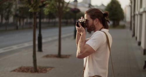 Male Photographer Taking Photos of Town on Vintage Camera