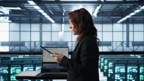 Technician in Data Center Using AI Tech on Tablet