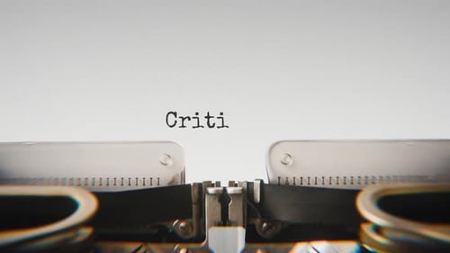 Old mechanical typewriter typing Critical Care in a close-up view.