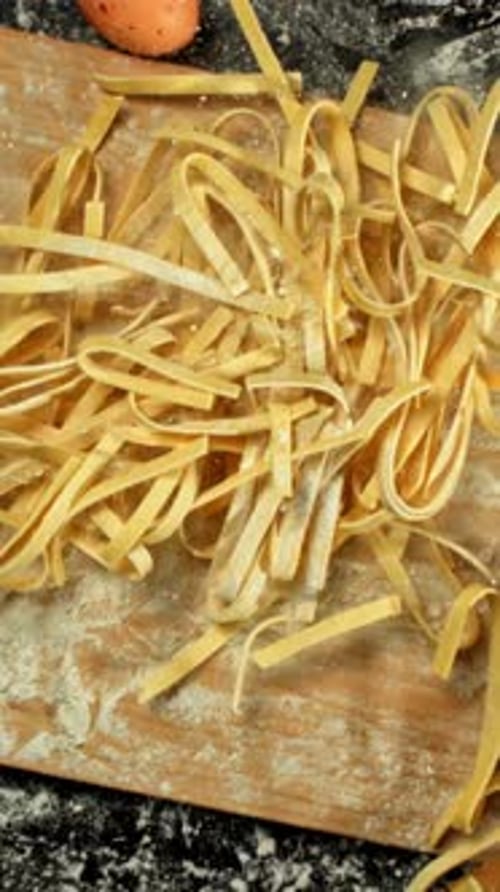 Homemade Fettuccine Pasta Falls on a Cutting Board View From Above