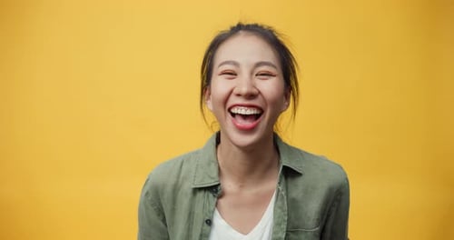 lady stand on isolate yellow empty space background looking at camera with toothy smile enjoy.