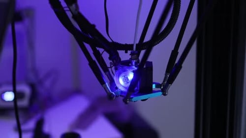 Close-up of a 3D Printer Head with Blue Light