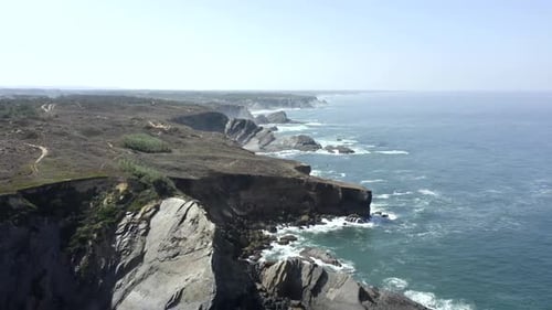 Aerial High Angle View Of Rugged Cliffs Along Vast Coastline