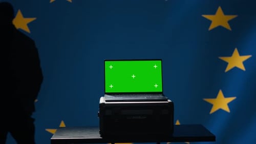 Laptop with Green Screen in Front of EU Flag