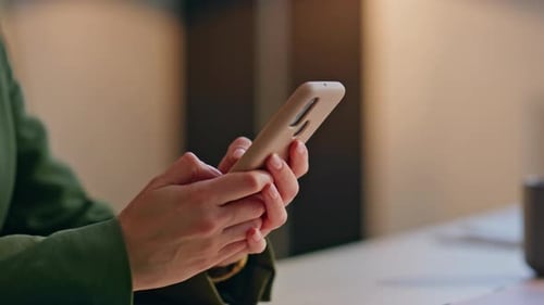 Woman Holds Mobile Phone Indoors