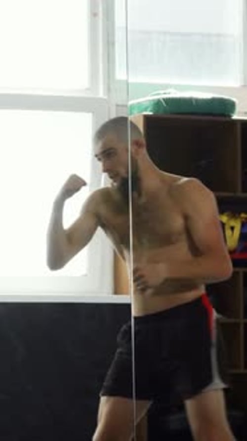 Young Adult Training Boxing Punches in Gym