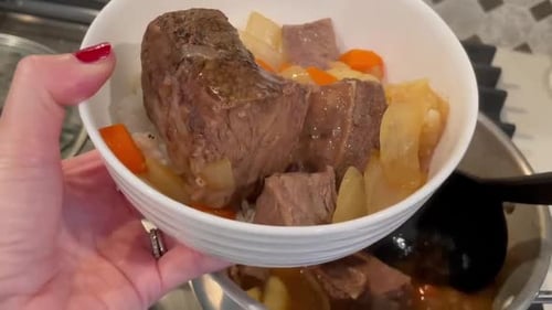 Korean Beef Short Rib Stew served over a bowl of sticky white rice. Close up.