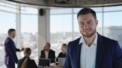 Portrait of a smiling entrepreneur standing in the office. Close up.