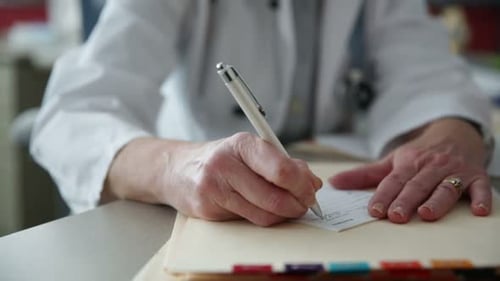Woman Doctor Writing Prescription in Office Setting