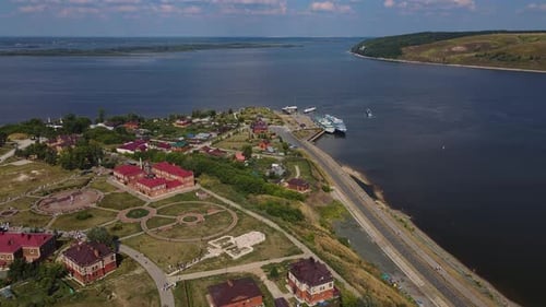 Enjoy the Picturesque Scenery of a Riverside Town with Boats From an Aerial View