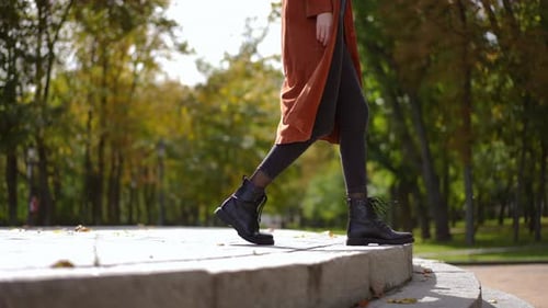 Side View Tracking Shot of Unrecognizable Slim Stylish Young Woman Walking Down on Stone Stairs in
