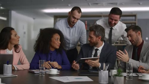 Diverse Business Group Researching Tablet Computer In International Marketing Office. Corporate P...