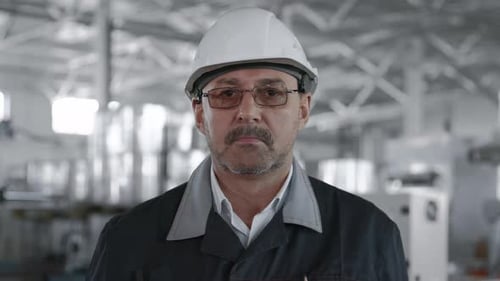 Engineer Planning Manufacture Work. Male Labor Person in Hardhat or Protective Clothes