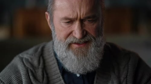 Closeup Upset Old Man Face Listening During Video Call At Home. Focused Senior Business Man Worki...