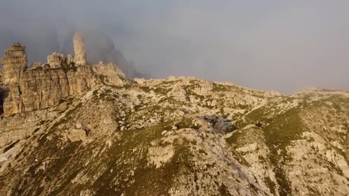 Aerial view of the Dolomites mountain range in morning fog, Italy