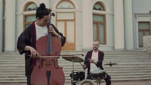Musical Group Playing Together Outside Building