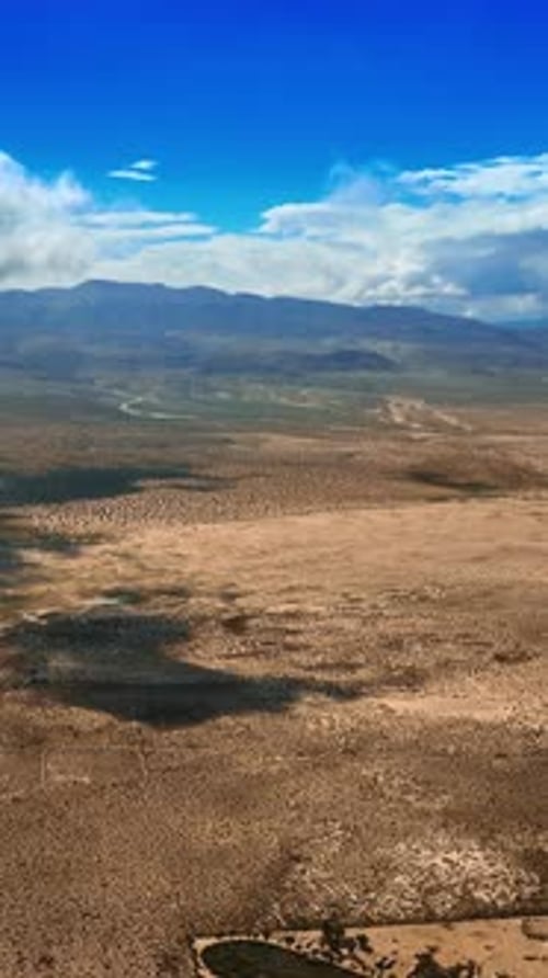 White cloudscape slowly floating in the air covering the desert from sun.