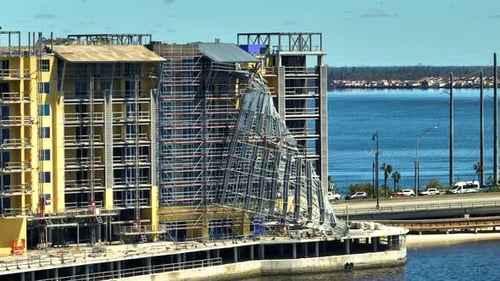 Aerial View of Ruined By Hurricane Ian Construction Scaffolding on High Apartment Building Site in