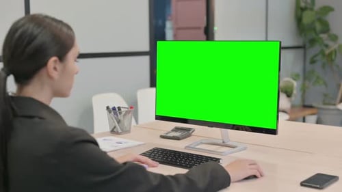 Young Businesswoman using Desktop with Green Screen