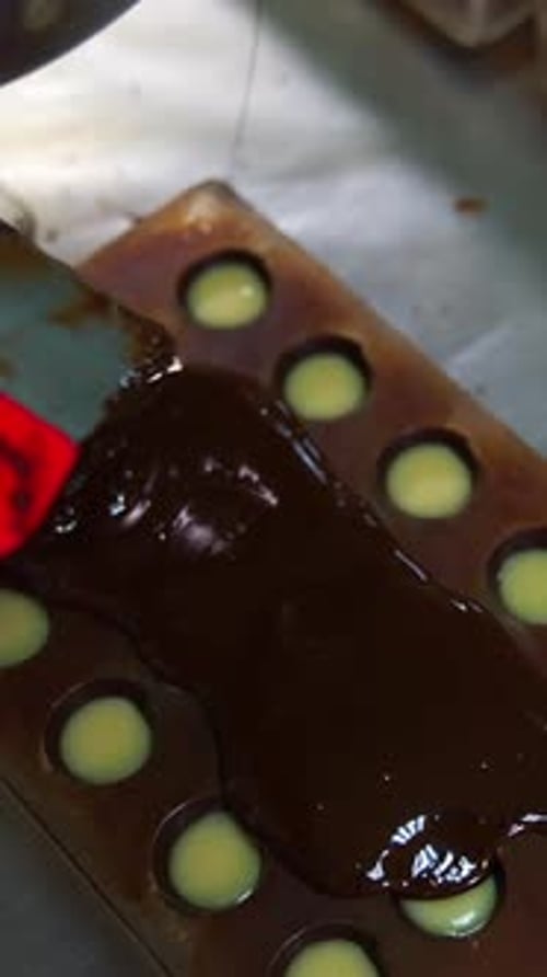 Filling Chocolate Mold with Dark Melted Chocolate