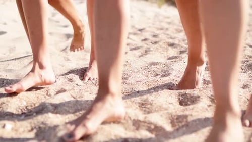 Close View of Women Tanned Legs and Feet Walking on Sandy Beach to the Ocean on Sunny Day Slim
