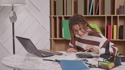Woman Working on Finances in Home Office