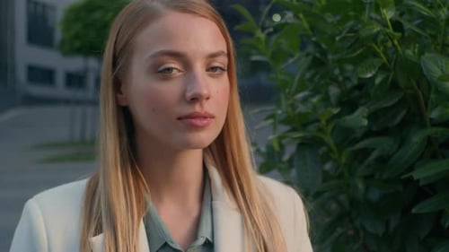 Young Woman in Blazer Smiling at Camera