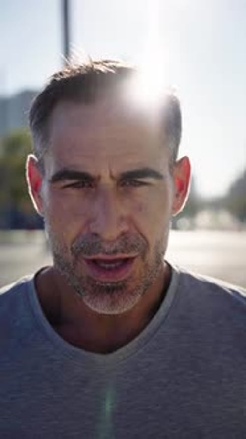 Man Talking to Camera Outdoors in Bright Daylight