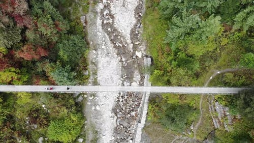 People Crossing Dron Bridge In Annapurna Nepal - aerial shot